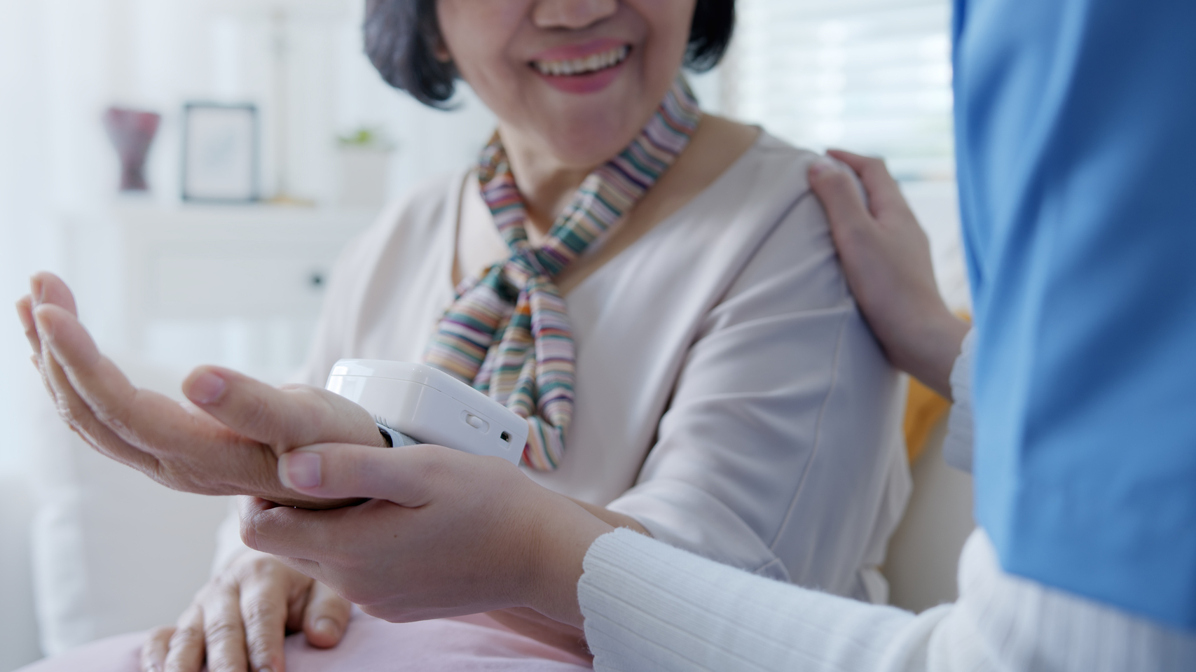 Scrub,nurse,doctor,using,digital,tonometer,check,blood,pressure,for