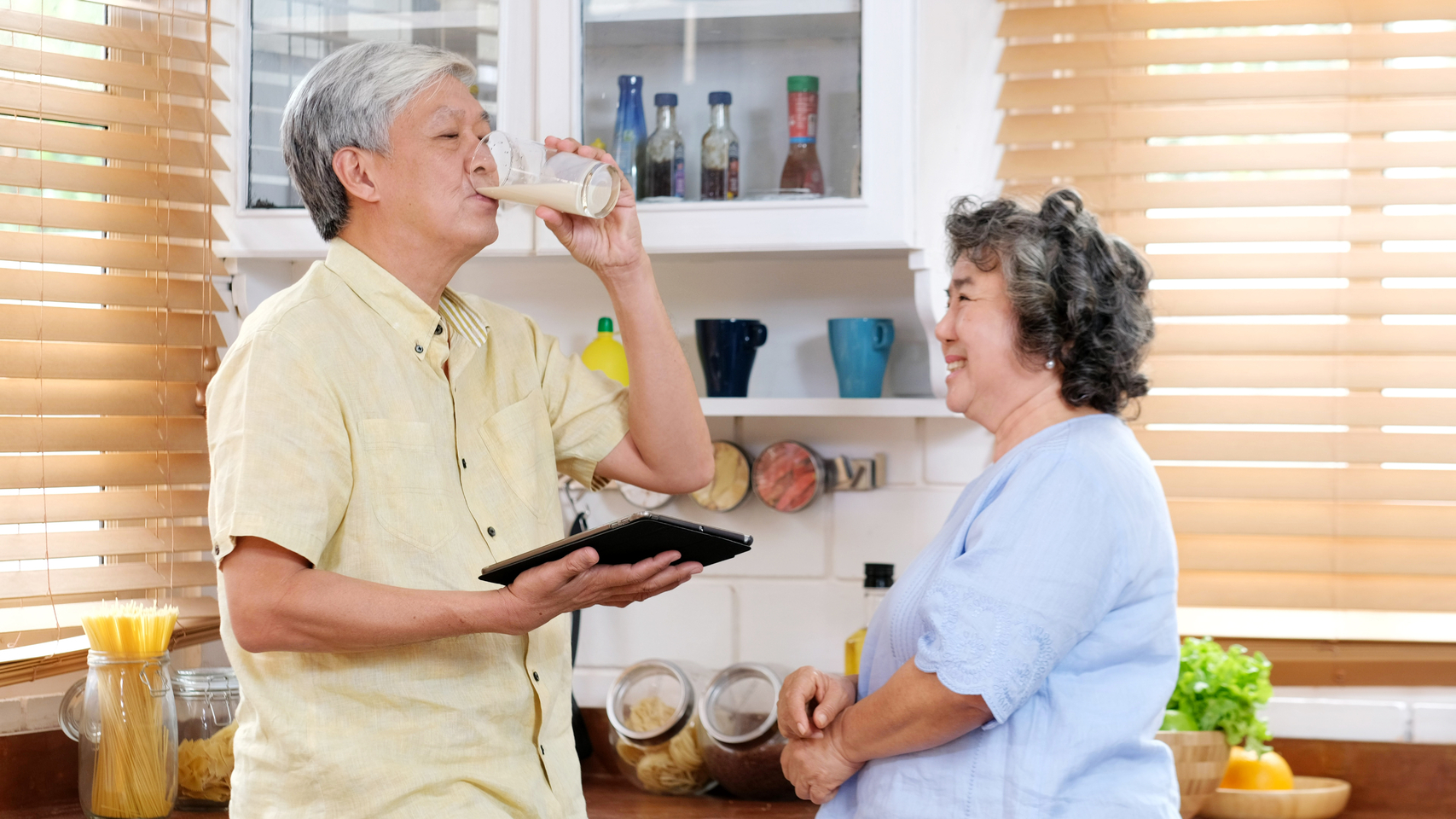Senior,couple,at,home,,old,asian,man,drinking,milk,at