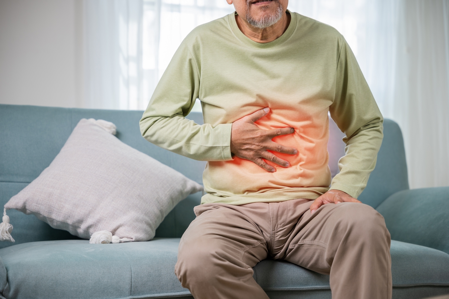 Senior,asian,man,sitting,on,sofa,having,suffering,from,stomach